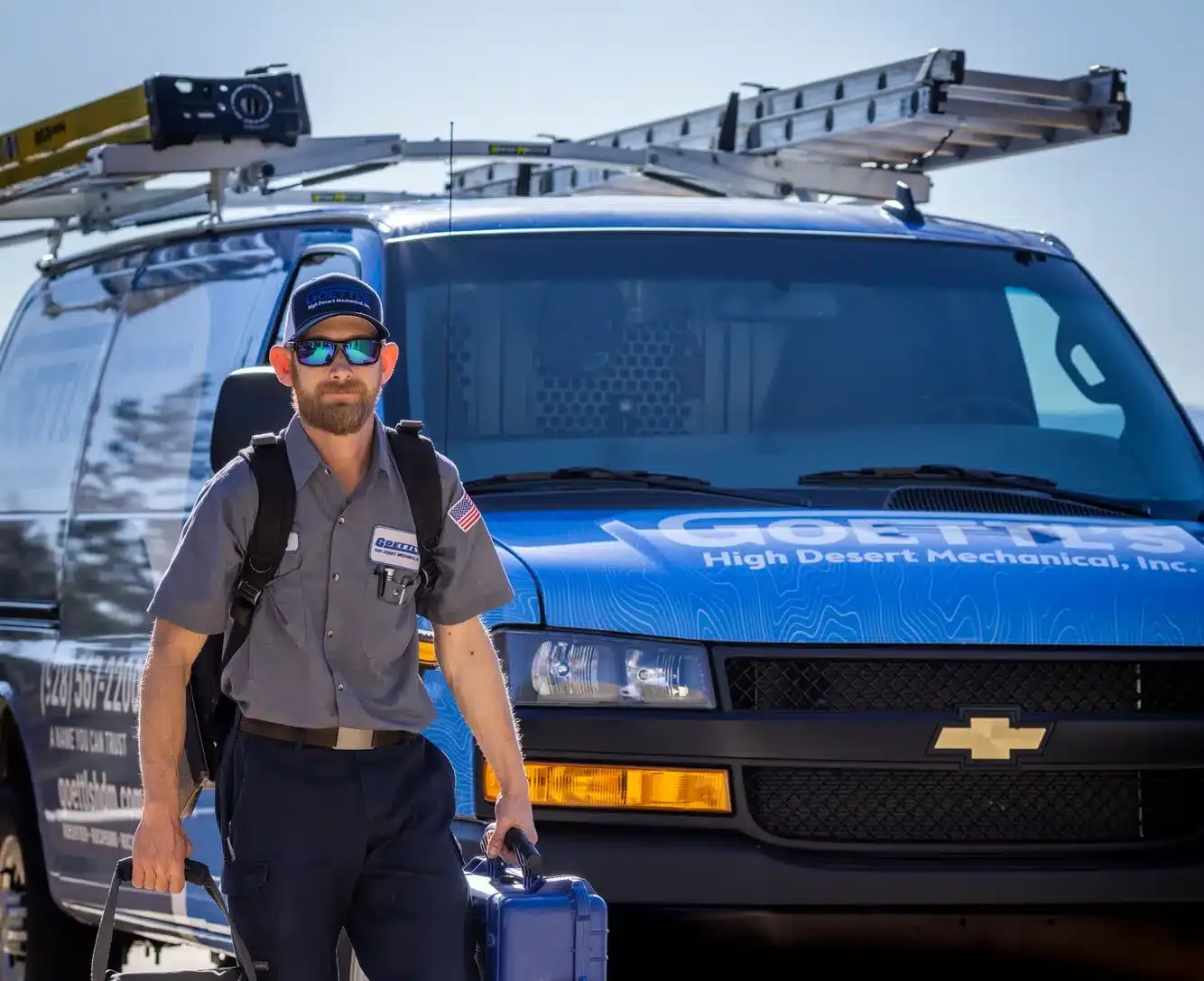 Goettl’s High Desert Mechanical technician walking toward service van carrying tools – Prescott Valley AZ